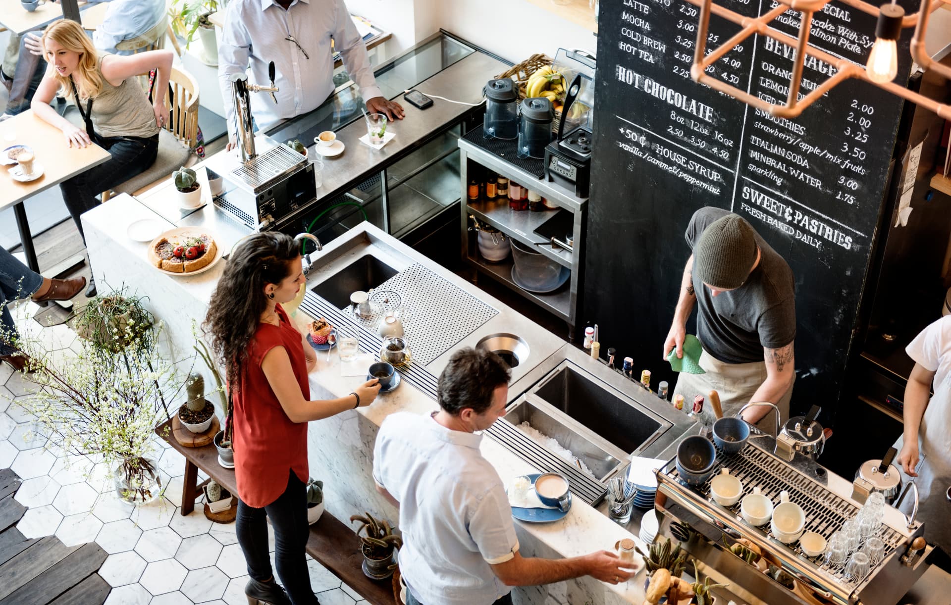Busy coffee shop counter with staff and customers